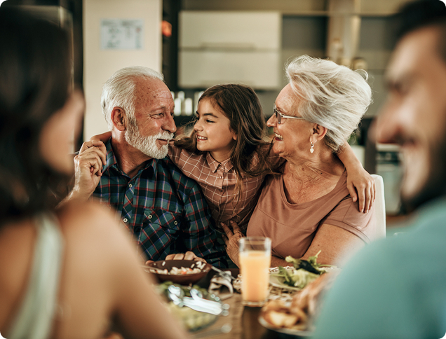 Grandparents enjoying a family meal, symbolizing legacy and financial security